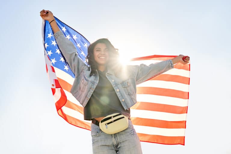 immigration female holding flag for immigration attorney Visalia