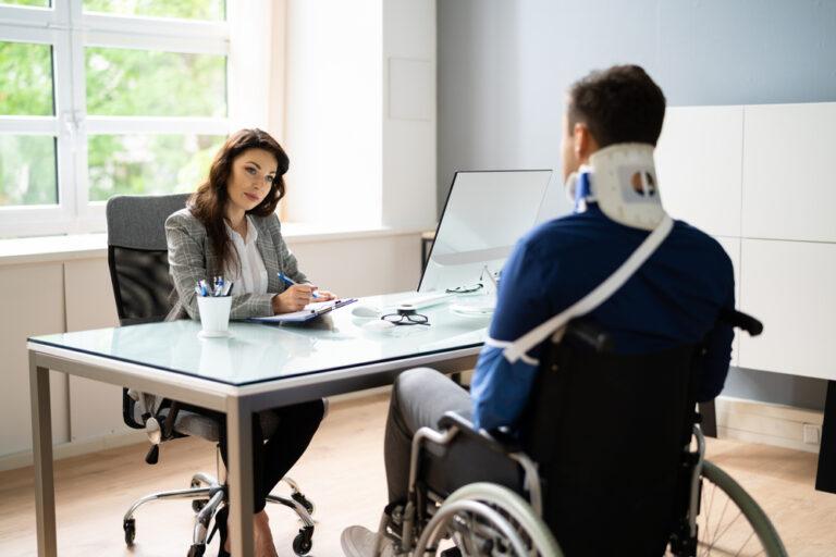 attorney and client sitting at table regarding personal injury attorney Hanford