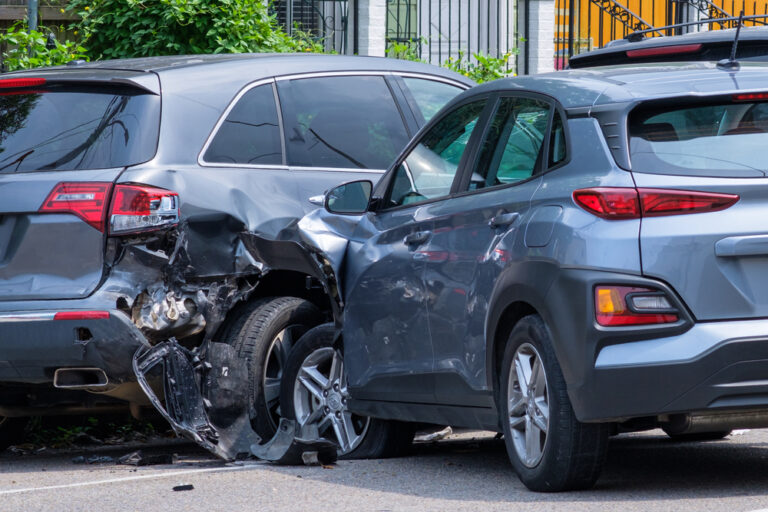 Senior male and female drivers get out of cars finding personal injury attorney Clovis