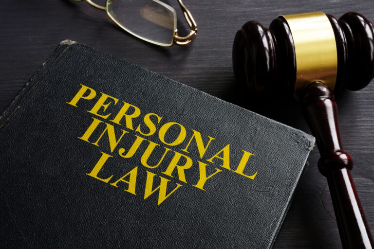 Injury Law book and a black desk at personal injury attorney Clovis