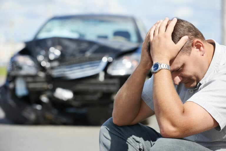 Adult upset man in front of automobile crash now personal injury attorney Visalia